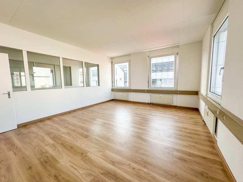 empty room, wooden floor, white walls, large windows, radiators