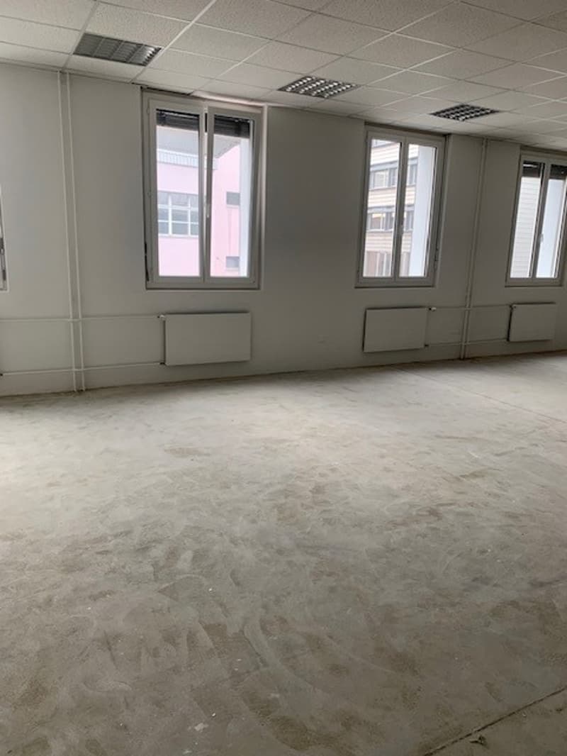 empty room with windows and heating radiators