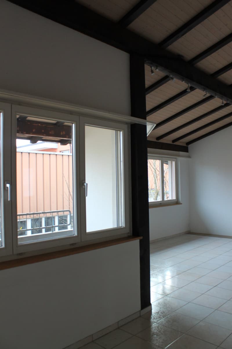 white tiles on floor, two large windows, balcony with metal railing