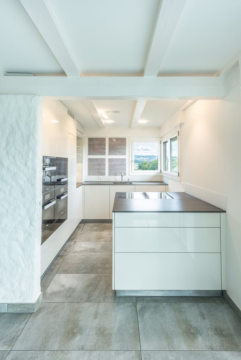 white cabinets, granite countertop, stainless steel appliances, double oven, window with mountain view