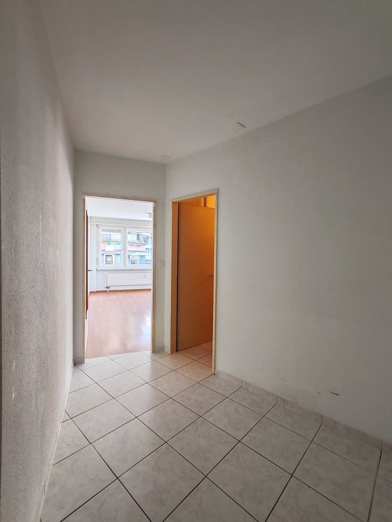tiled floor, white walls, door leading to a balcony