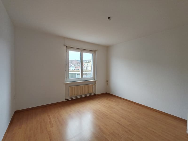 empty room, large window, white walls, wooden floor, central heating