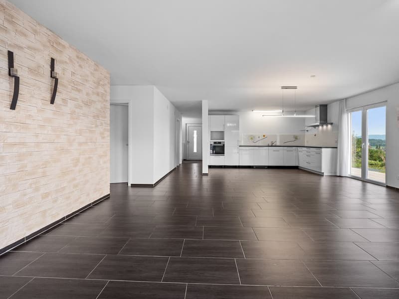 Modern open kitchen with living room, white cabinets, tiled floor, windows