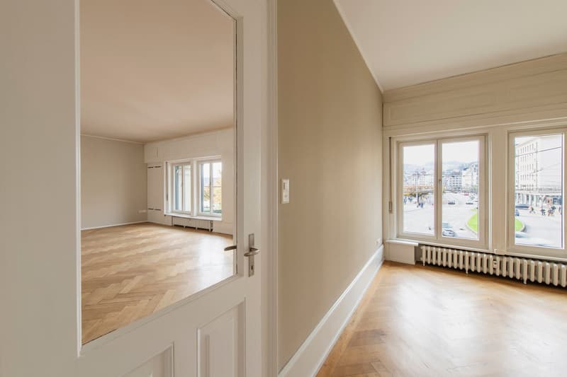 empty room, large windows, wooden floor, radiators, door