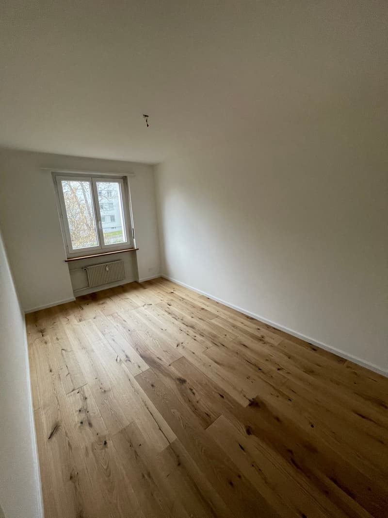 empty room, wooden floor, large window, white walls, window sill, small wall heater