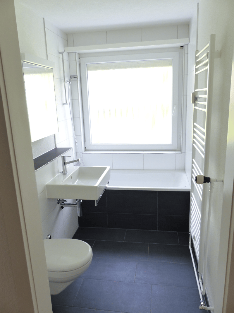 Bathroom with toilet, sink, bathtub, and shower