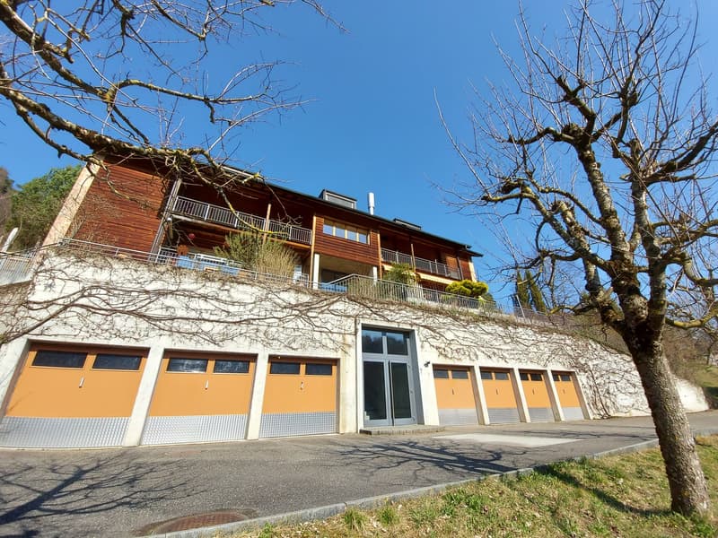 Wooden building with multiple garages and balconies