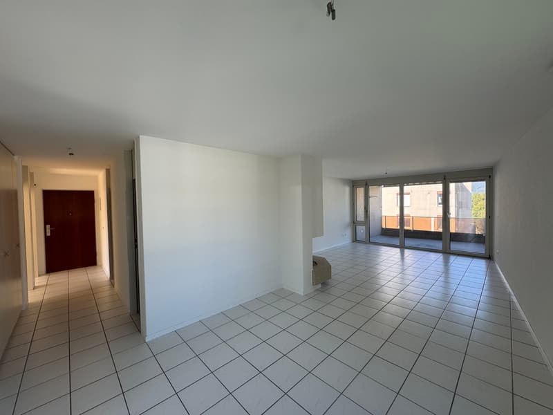 empty room, white tiles, brown door, sliding glass door, balcony