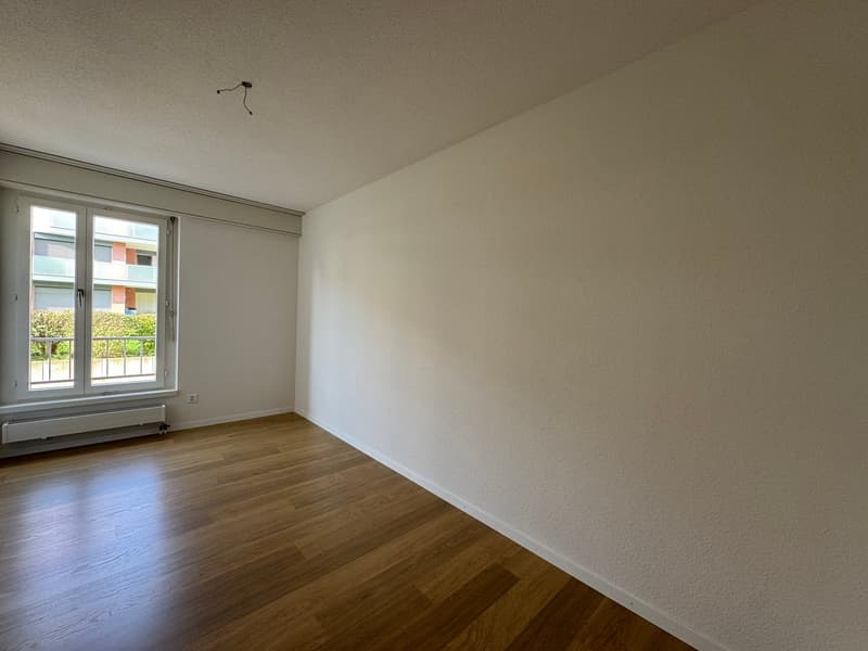empty room, white walls, hardwood floors, large window with balcony