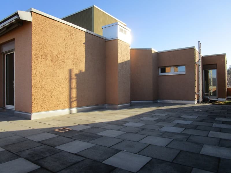 exterior with raised ground floor, beige exterior walls, large windows, glass door, tile floor