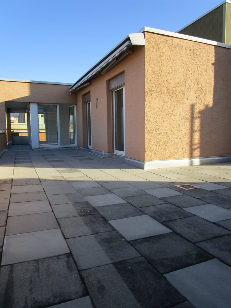 tiled rooftop patio, glass doors, balcony on the left side, shadow