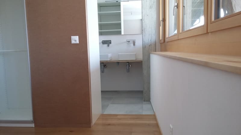 Bathroom with shower, sink, and shelves