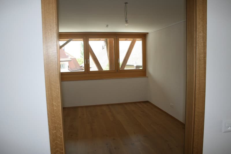 empty room, wooden floor, white walls, large window, wooden window frame