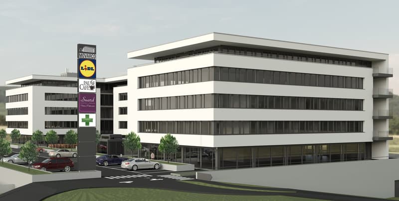 Modern office building with glass facade, multiple floors, parking area, trees, and a signboard with various logos