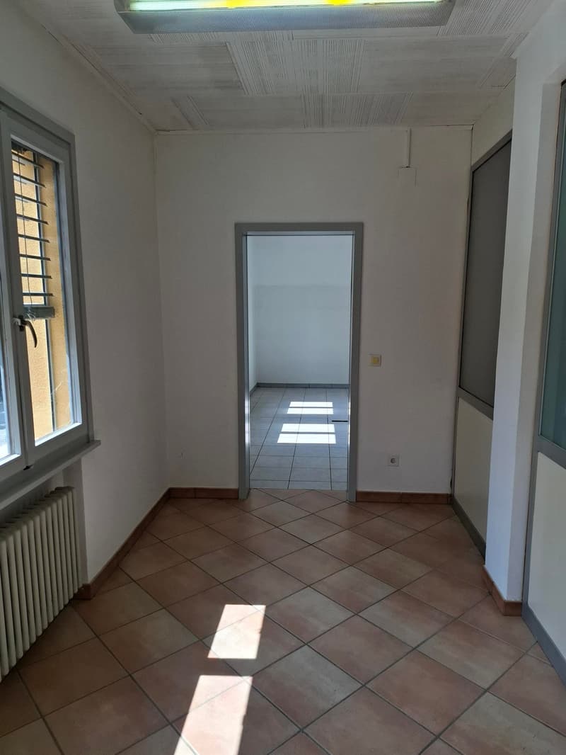 empty room, tiled floor, white walls, window, entrance to another room, heater