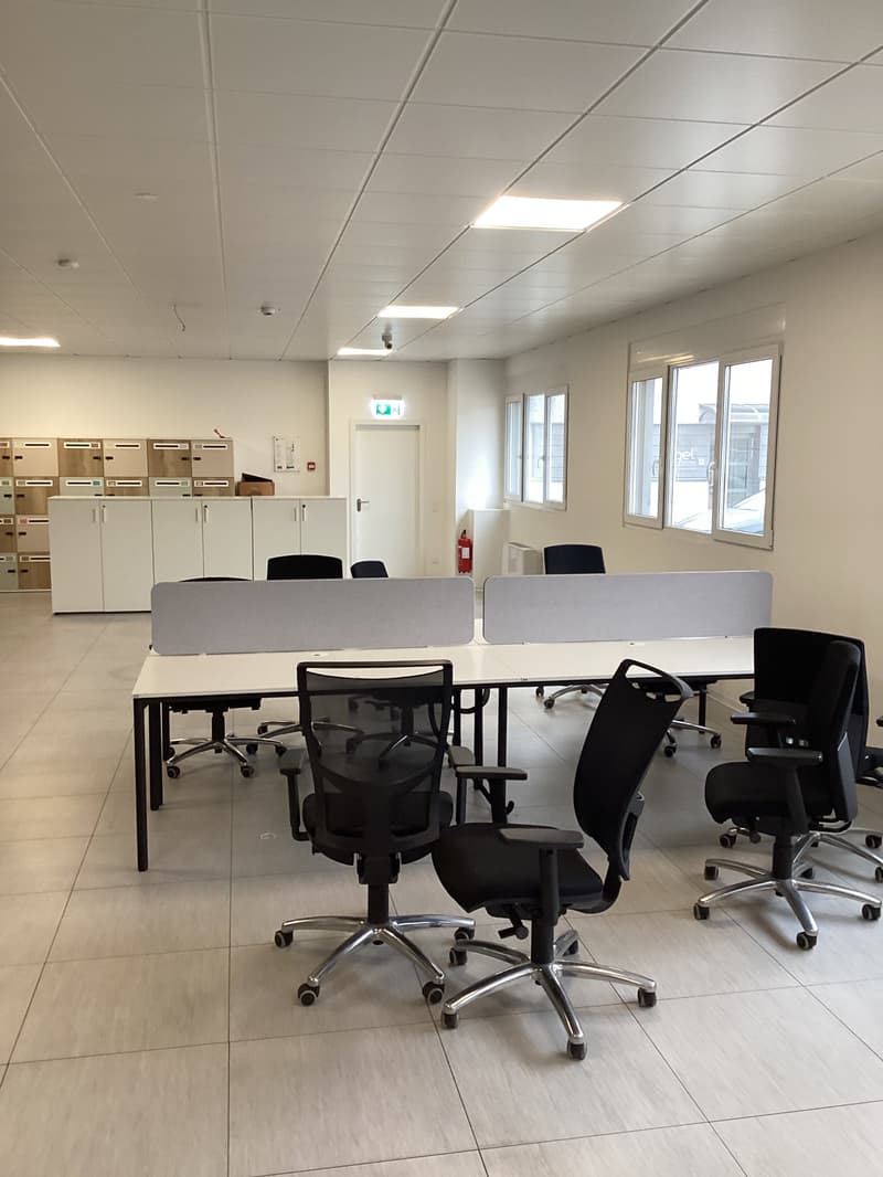 spacious office, desk and office chairs, white cabinets, windows, white tile flooring