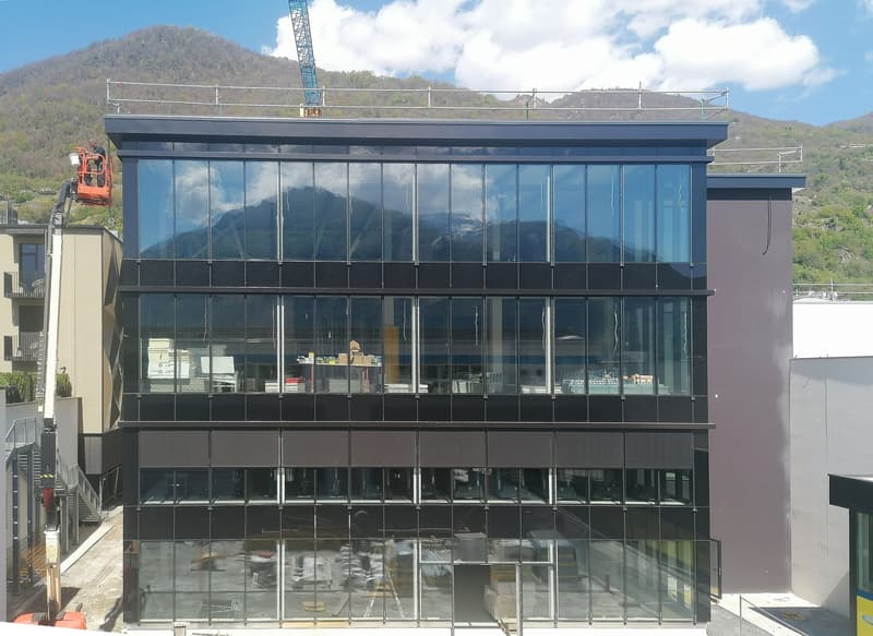 modern office building, glass facade, multiple floors, mountain view