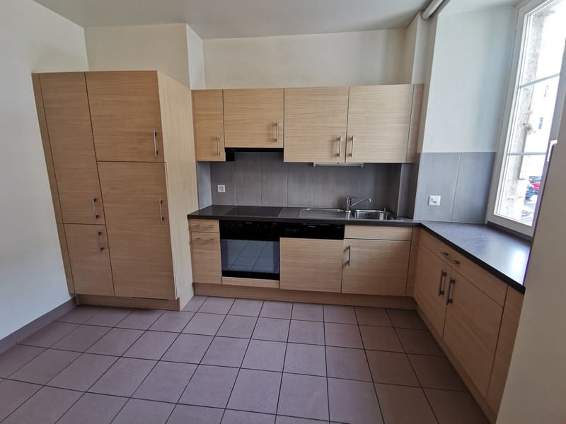 modern kitchen with stainless steel appliances, wooden cabinets, tile flooring, window
