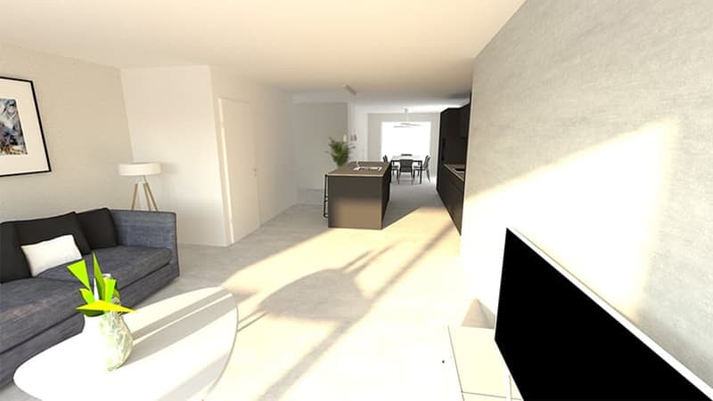 open-concept living room with grey sofa, coffee table, and kitchen visible in the background, large windows allowing natural light