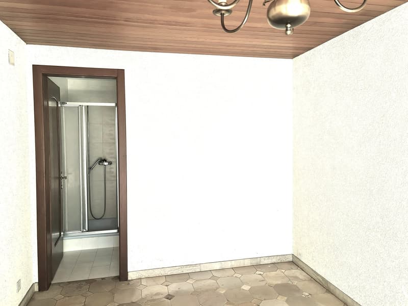 Bathroom with glass shower enclosure, tiled floor, and wooden ceiling