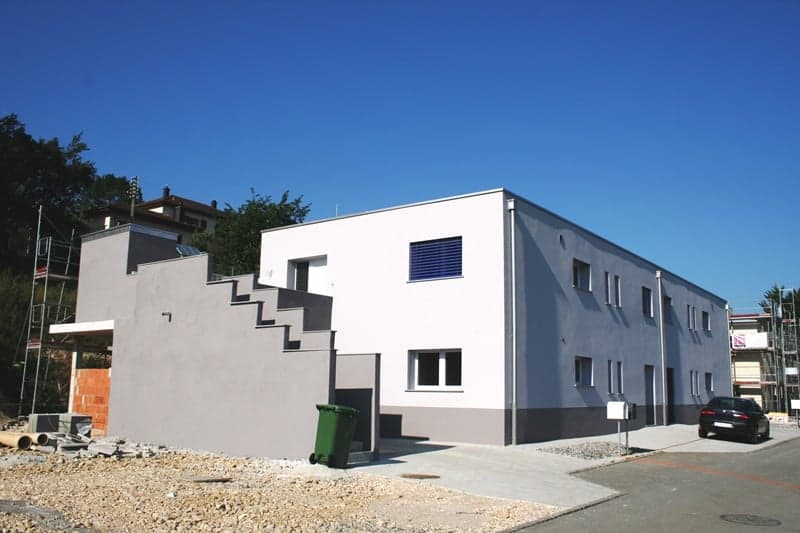 Modern architecture, two story house, white and gray walls, staircase leading to upper floor, car parked in front