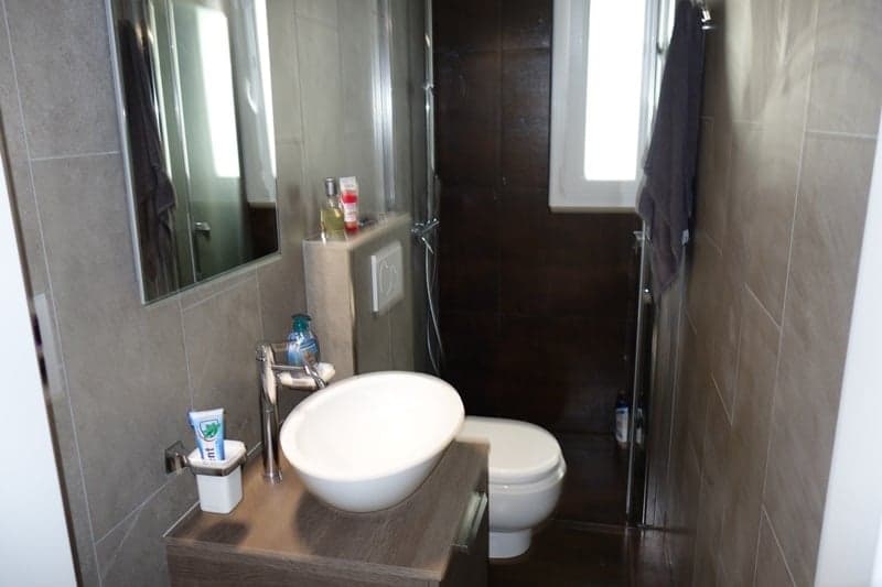 bathroom with toilet, sink, and mirror