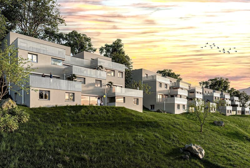 A modern apartment complex built on a slope with raised ground floor, balconies on multiple levels, large windows, and lush surroundings.