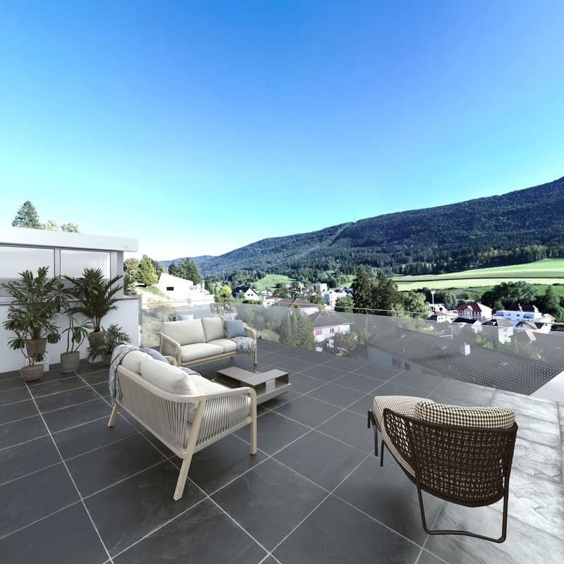 Balcony, black floor tiles, beige and white chairs, central table, glass railings, mountains in the background.