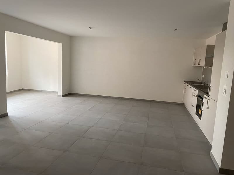 empty room, tiled floor, white walls, white kitchen, white cupboards, sink, oven