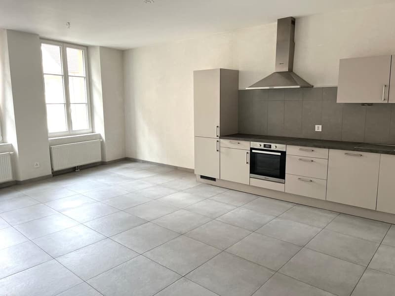 empty kitchen with tiled floor, gray cabinets, gray countertop, embedded oven, extractor hood, window, radiators