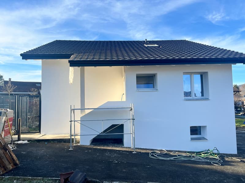 new construction, modern, white facade, slate roof, basement entrance, windows, balcony, construction site