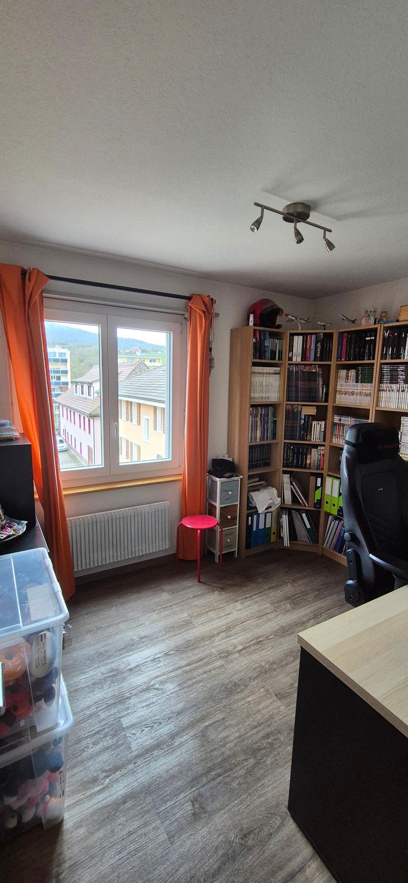 wooden floor, window, radiator, desk, bookshelf, chair, cabinet, storage boxes, storage bins