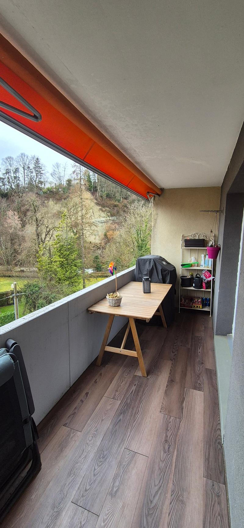 wooden floor, wooden table, balcony with view of trees and mountains