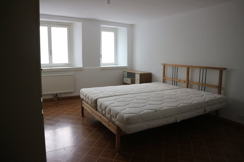 wooden beds, wooden cabinet, radiator, brown tiles