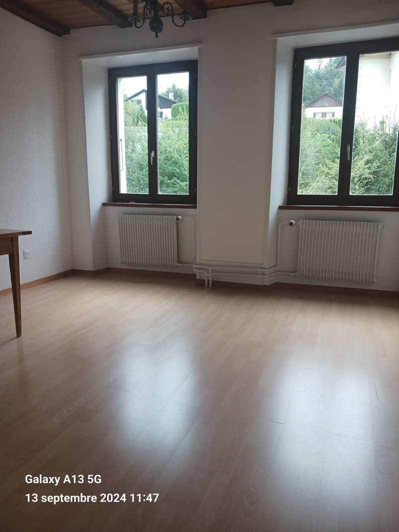 empty room, wooden floor, white walls, two windows, white radiators, wooden table