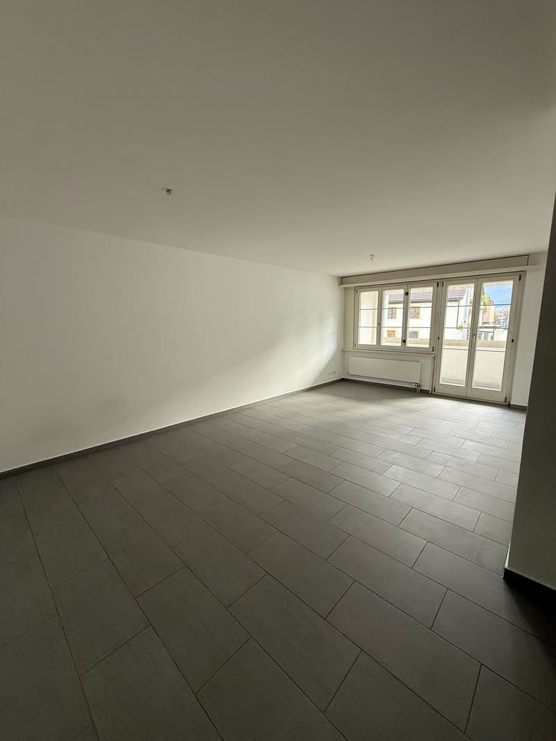 empty room, white walls, tiled floor, sliding glass doors, window with white shutters