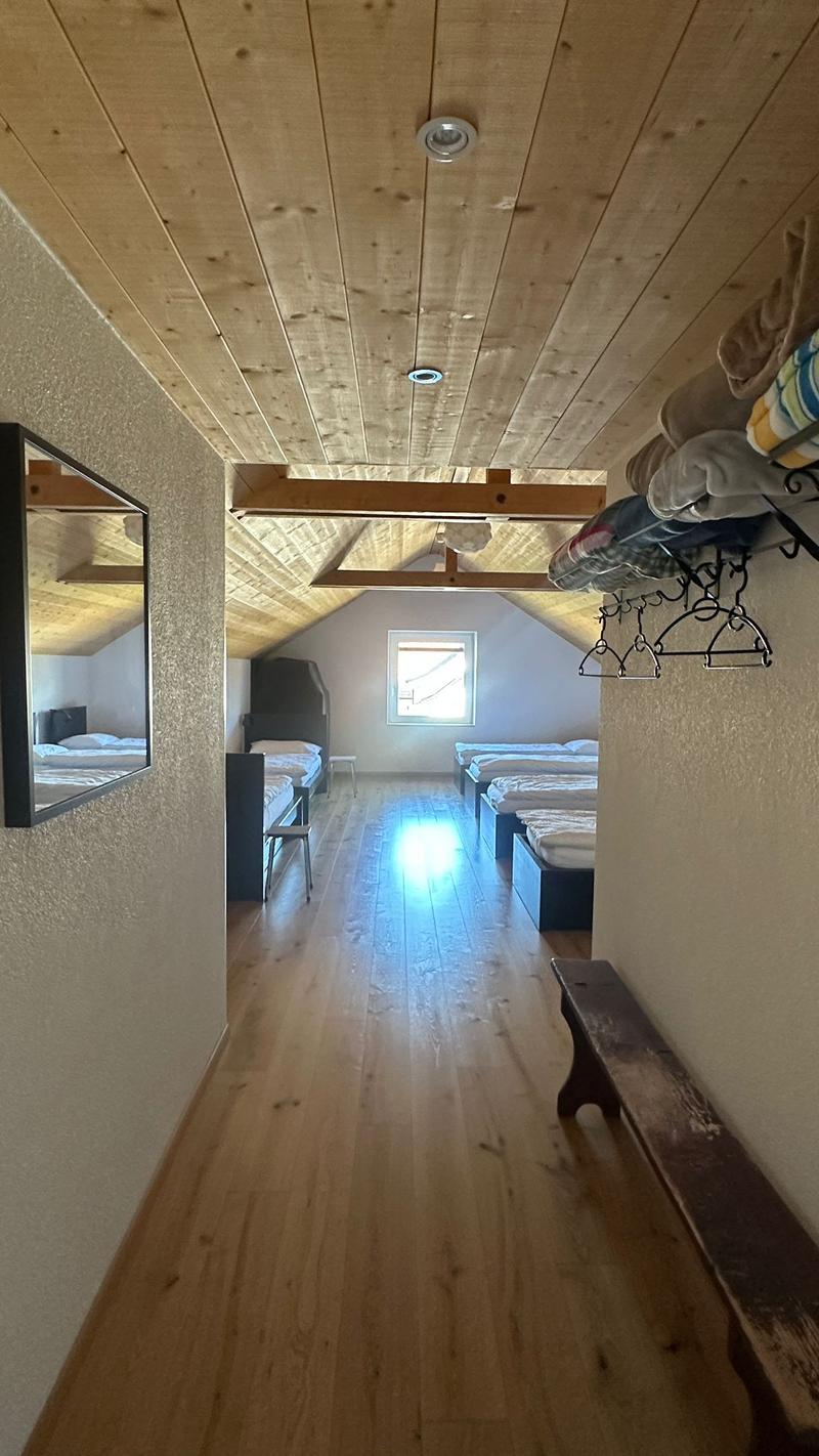 multiple beds, window, mirror, wooden floor, ceiling