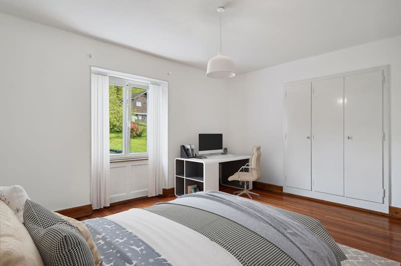 bedroom with desk, chair, monitor, lamp, bed, pillows, rug, wardrobe, window, curtains