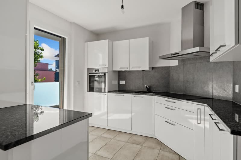 white cabinets, granite countertop, integrated appliances, tiled floor, stainless steel chimney
