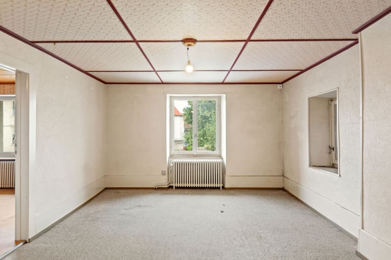 empty room with radiator, window, carpet, and white walls