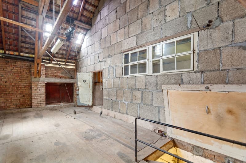 empty room, wooden floor, brick walls, open window, wooden door, metal handrail, lamps
