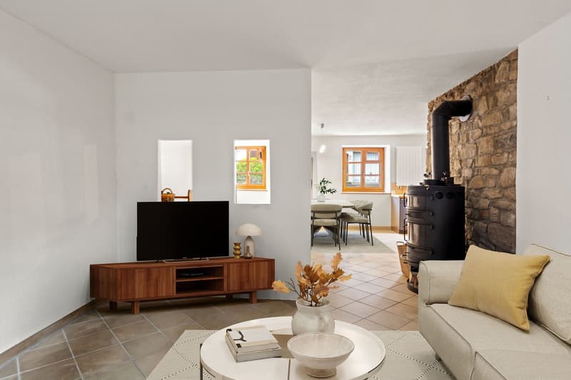 Cozy living room with sofa, coffee table, TV, fireplace, shelves