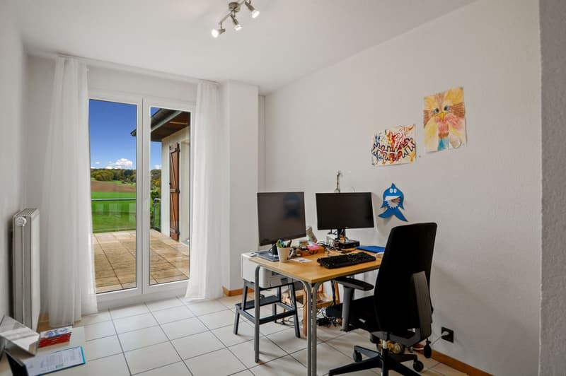 desk with two monitors, chair, curtains on windows, floor tiles, radiator, balcony outside