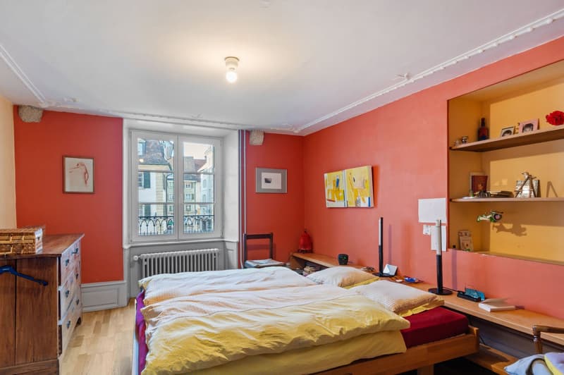 double bed, hardwood floor, double wardrobe, desk, window with balcony view