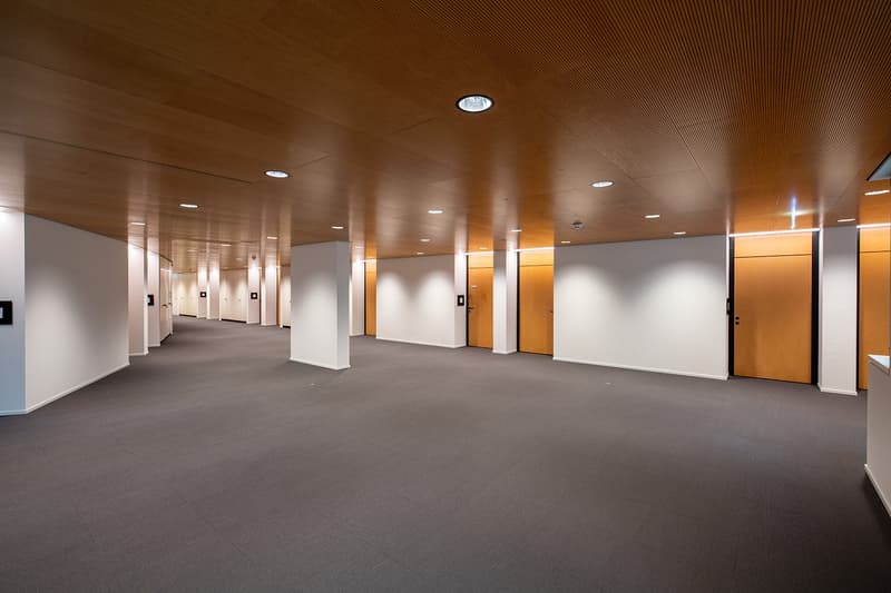 Spacious hallway, tiled flooring, recessed lighting, wooden ceilings, doors on both sides