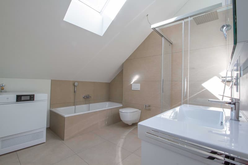 white tiled floor, bathtub, toilet, walk-in shower, sink, showerhead, washing machine
