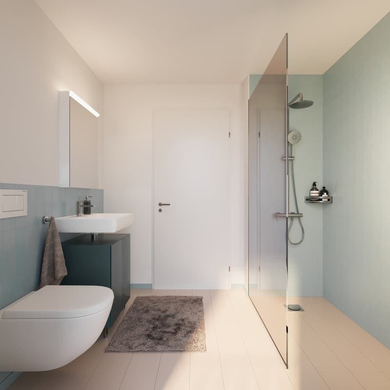 White toilet, blue tiles, glass shower enclosure, white sink, modern lighting, wall-mounted mirror, dark-colored rug, vanity with black cabinet