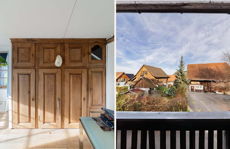 Interior: large wooden wardrobe with open upper door; Exterior: view of rural landscape with wooden houses