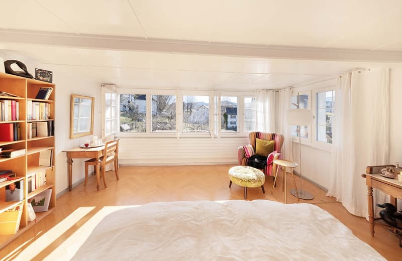 bedroom with bed, chair, desk, books, windows, curtains
