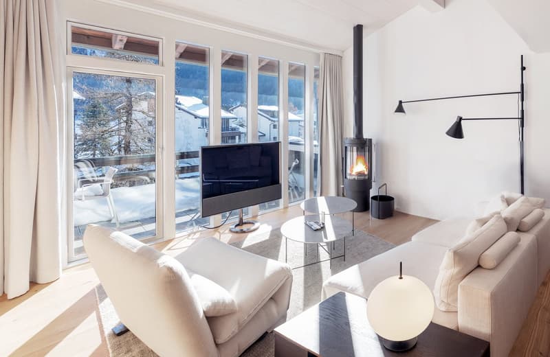 wooden floor, two sofas, two tables, large glass windows, fireplace, TV, remote control